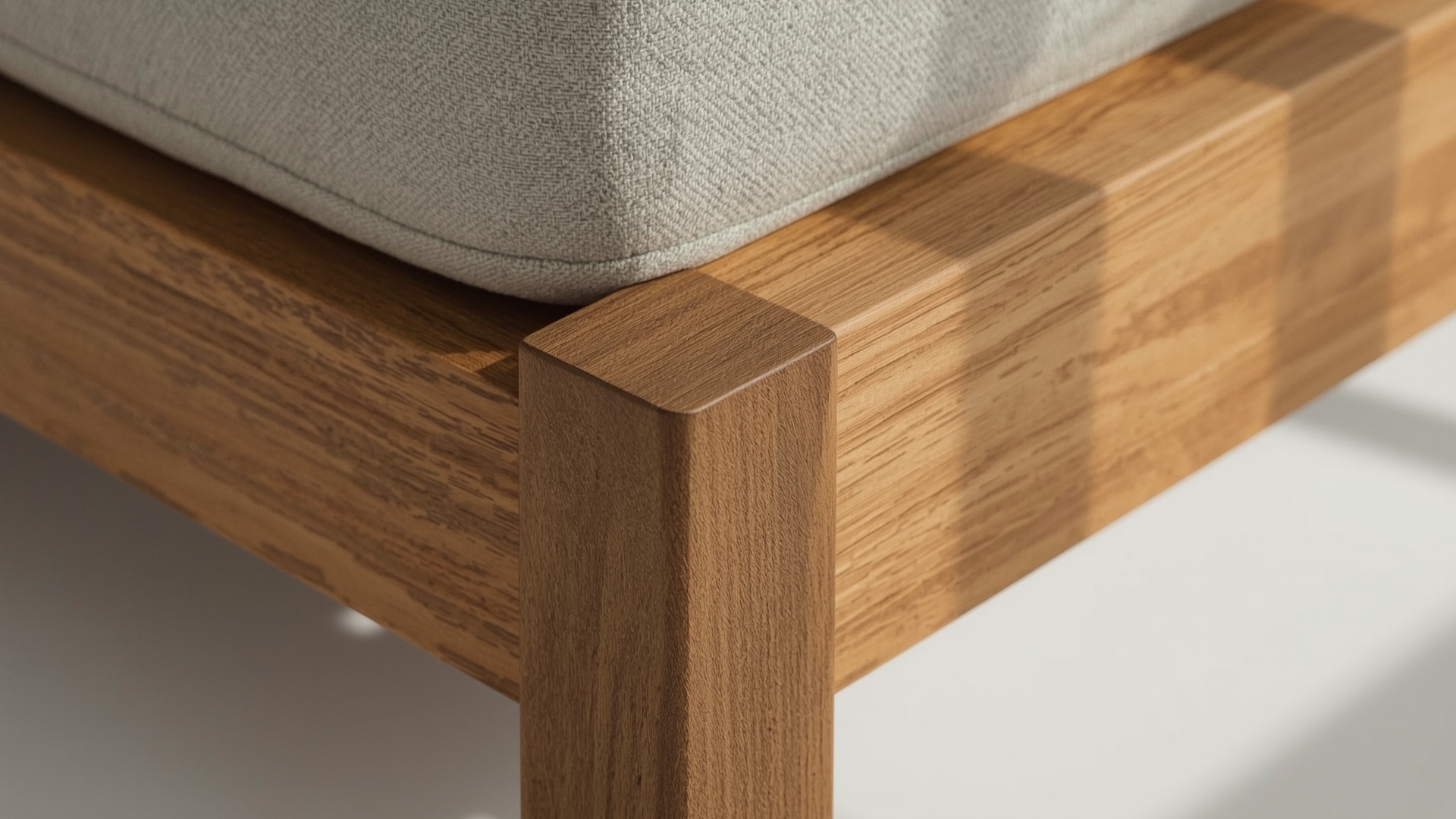 Close-up of premium sofa hardwood frame joinery and upholstery craftsmanship detail